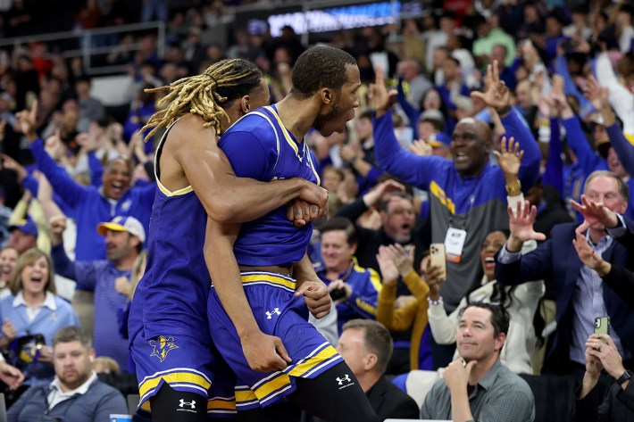 PROVIDENCE, RHODE ISLAND - MARCH 20: Quadir Copeland #11 and Christian Shumate #24 of the McNeese State Cowboys celebrate after defeating the Clemson Tigers with a score of 69 to 67 in the first round of the NCAA Men's Basketball Tournament at Amica Mutual Pavillion on March 20, 2025 in Providence, Rhode Island.