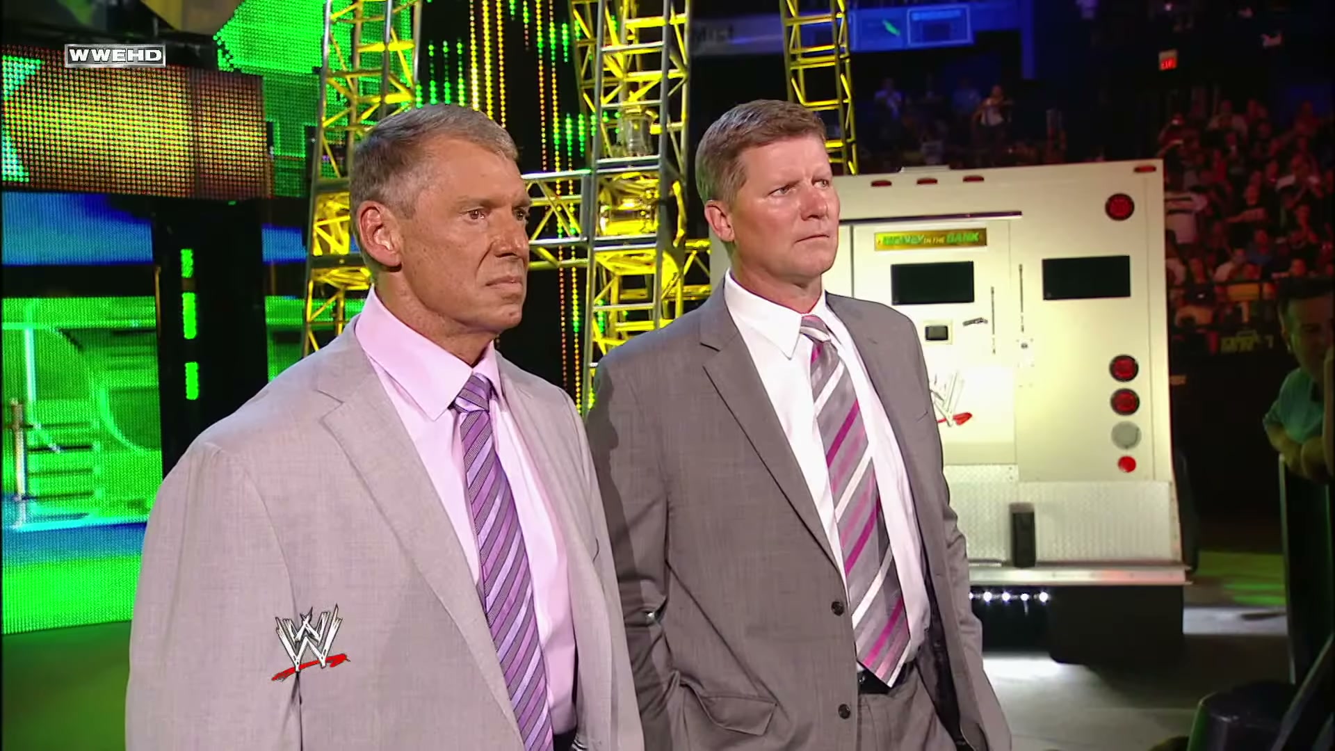 Vince McMahon and John Laurinaitis look on during the main event of Money in the Bank 2011.